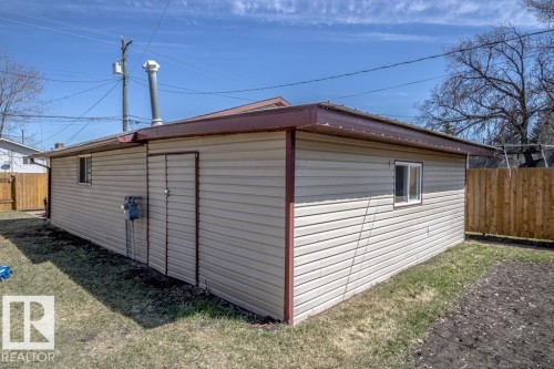 Detached structure featuring light-toned horizontal siding, a brown trim, and a matching brown metal roof - 4822 45 Ave, St. Paul Town, AB - Outdoor