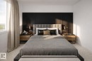 Bedroom featuring a paneled accent wall, upholstered headboard, and dual-drawer nightstands with stone tops - 18 Brickyard View, Stony Plain, AB  - Indoor Photo Showing Bedroom 