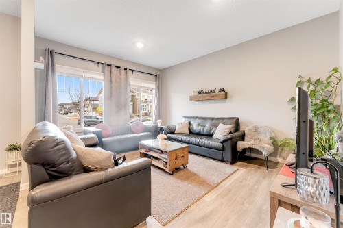 Spacious living area featuring light wood-finish flooring and neutral wall tones - 2652 Maple Way, Edmonton, AB - Indoor Photo Showing Living Room