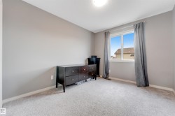 Spacious room featuring light gray walls and a large double-pane window with white trim - 