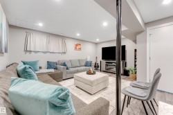 Recreation room featuring recessed lighting, light gray walls, wood-finish flooring, and a built-in media console - 