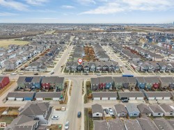 Aerial perspective showcasing a residential development with multiple streets and distinct housing styles - 