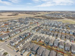 Residential development featuring multiple single-family homes and townhomes with various rooflines and exterior finishes - 
