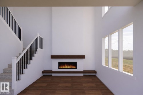 Two-story living area featuring a fireplace with a wood-finish mantle, large windows, wood-finish flooring, and a carpeted staircase with a black spindle railing - 20 Brickyard View, Stony Plain, AB - Indoor Photo Showing Other Room With Fireplace