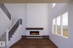 Two-story living area featuring a fireplace with a wood-finish mantle, large windows, wood-finish flooring, and a carpeted staircase with a black spindle railing - 