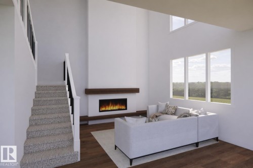 Vaulted ceiling great room featuring a modern fireplace with a wood mantel, wood-finish flooring, and multiple windows providing natural light - 20 Brickyard View, Stony Plain, AB - Indoor With Fireplace