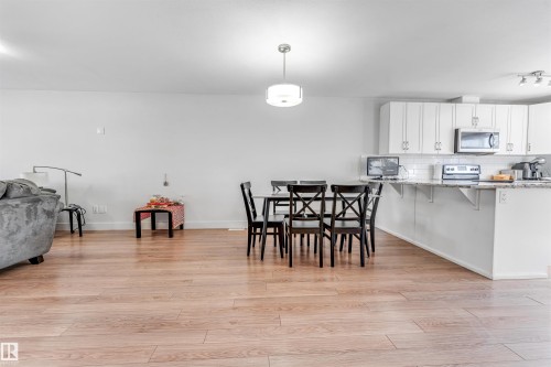 Open-concept living space with light wood-finish flooring throughout - 1536 21 Street, Edmonton, AB - Indoor