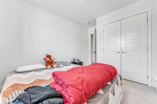 Bedroom featuring wall-to-wall carpeting, white painted walls, and a ceiling-mounted light fixture - 1536 21 Street, Edmonton, AB - Indoor Photo Showing Bedroom