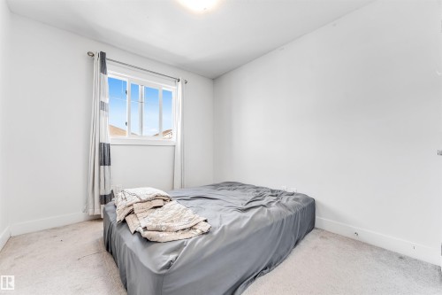 Room featuring a window with white trim, light-colored walls, and carpet flooring - 1536 21 Street, Edmonton, AB - Indoor Photo Showing Bedroom