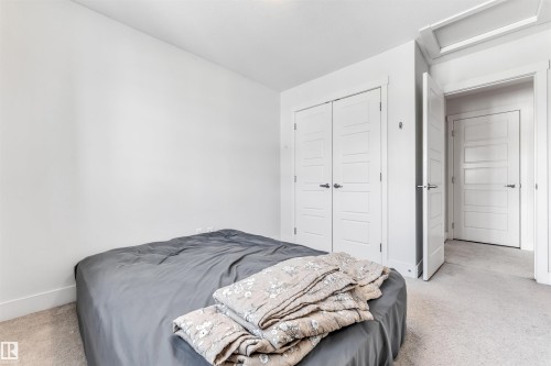 Neutral wall color with baseboard molding and light-colored carpet - 1536 21 Street, Edmonton, AB - Indoor Photo Showing Bedroom