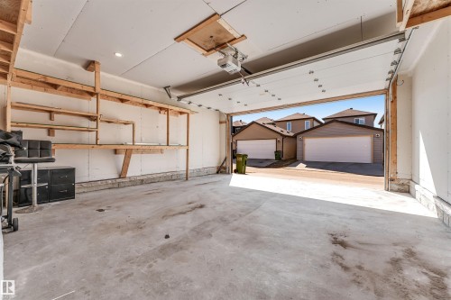 Spacious garage featuring concrete flooring and built-in shelving - 1536 21 Street, Edmonton, AB - Indoor Photo Showing Garage