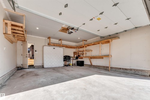 Spacious garage with concrete flooring and overhead garage door system - 1536 21 Street, Edmonton, AB - Indoor Photo Showing Garage