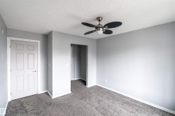 Room featuring light gray painted walls and dark gray carpeting - 