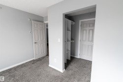 Interior room featuring grey carpeting, light grey wall paint, and white trim - 