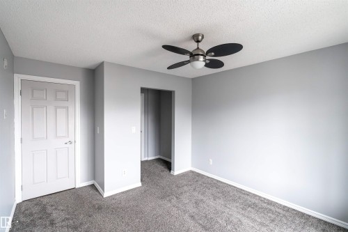 Room featuring light gray painted walls and dark gray carpeting - 4407 23 Street, Edmonton, AB - Indoor Photo Showing Other Room