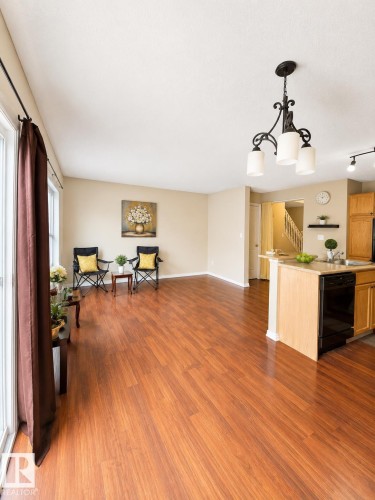 Spacious living area featuring wood-finish flooring - 704 83 Street, Edmonton, AB - Indoor
