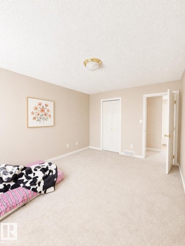 Wall-to-wall carpeting with light-toned walls and white trim - 704 83 Street, Edmonton, AB - Indoor Photo Showing Bedroom