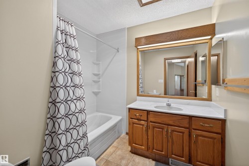Bathroom featuring a white bathtub and shower surround with integrated shelving - 19403 Fort Road, Edmonton, AB - Indoor Photo Showing Bathroom