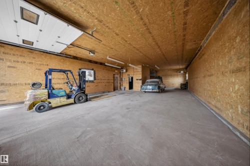 Spacious interior featuring a concrete floor, oriented strand board walls, and a wood-finish ceiling - 19403 Fort Road, Edmonton, AB - Indoor Photo Showing Garage