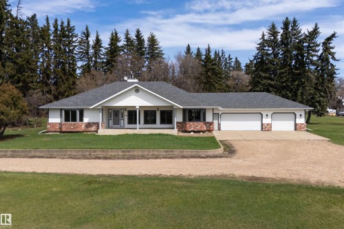 Ranch-style residence featuring a prominent gabled entry and a stone and white siding exterior - 19403 Fort Road, Edmonton, AB - Outdoor With Facade