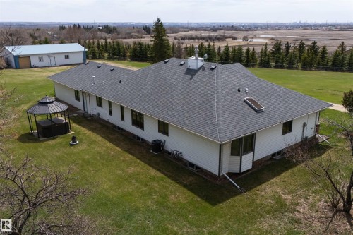 Ranch-style residence featuring white siding and a gray asphalt shingle roof with a skylight - 19403 Fort Road, Edmonton, AB - Outdoor