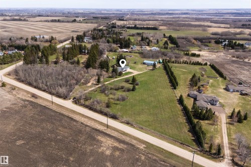 Expansive property featuring significant green space, a detached structure, and a perimeter of mature trees - 19403 Fort Road, Edmonton, AB - Outdoor With View