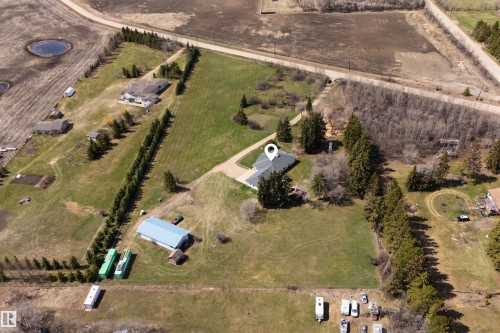 Expansive rural property featuring a single-story residence with a dark roof and surrounding mature trees - 19403 Fort Road, Edmonton, AB - Outdoor With View
