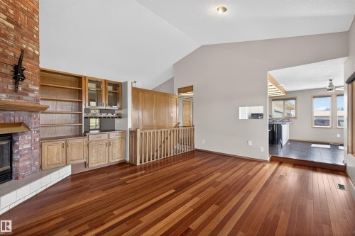 Spacious living area featuring wood-finish flooring and a vaulted ceiling - 19403 Fort Road, Edmonton, AB - Indoor With Fireplace