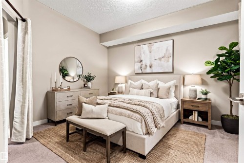 Bedroom featuring plush carpeting, neutral wall tones, window treatments, a built-in light shelf, and recessed ceiling lighting - 316 10520 56 Avenue Nw, Edmonton, AB - Indoor Photo Showing Bedroom