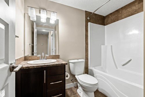 Full bathroom featuring a white tub-shower combination with a curved shower rod - 316 10520 56 Avenue Nw, Edmonton, AB - Indoor Photo Showing Bathroom