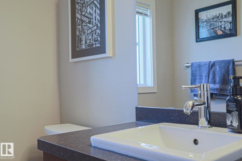 Convenient Main living area 2 piece Bathroom vanity featuring a rectangular undermount sink and a polished chrome faucet - 1622 33A Street Nw, Edmonton, AB - Indoor Photo Showing Bathroom