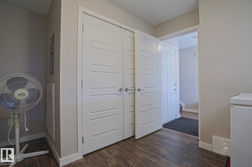 Laminate flooring throughout  Main floor storage and furnace room with access to the double garage. - 1622 33A Street Nw, Edmonton, AB - Indoor