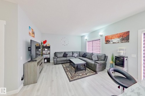 Spacious living area featuring light wood-finish flooring - 1221 27 Street, Edmonton, AB - Indoor Photo Showing Living Room