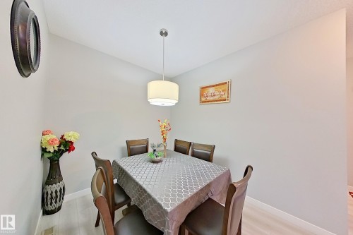 Dining area featuring neutral wall tones, a contemporary drum pendant light fixture, and light wood-finish flooring - 1221 27 Street, Edmonton, AB - Indoor Photo Showing Dining Room