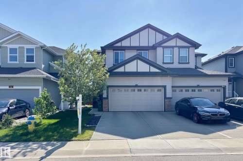 Two-story residence featuring light-toned siding with dark trim accents - 1221 27 Street, Edmonton, AB - Outdoor With Facade