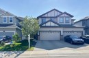 Two-story residence featuring light-toned siding with dark trim accents - 1221 27 Street, Edmonton, AB  - Outdoor With Facade 