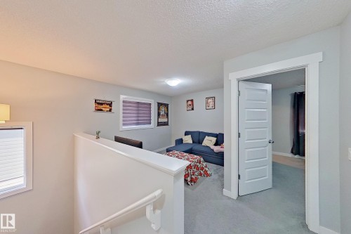 Upper-level landing featuring light gray walls, white trim, and gray carpeting - 1221 27 Street, Edmonton, AB - Indoor