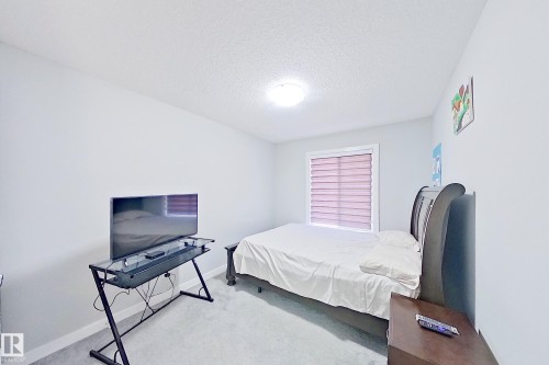 Bedroom with light gray walls and textured white ceiling - 1221 27 Street, Edmonton, AB - Indoor Photo Showing Bedroom