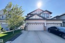 Two-story residence featuring light-colored siding with dark trim accents - 1221 27 Street, Edmonton, AB  - Outdoor 