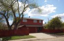 Red exterior featuring a two-car garage, white framed windows, and a deep red privacy fence - 12137 50 Street, Edmonton, AB  - Outdoor 