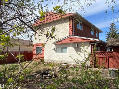 Exterior stucco siding with horizontal wood panel accents - 12137 50 Street, Edmonton, AB - Outdoor