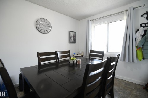 Townhomes often lack a large eating area.  Not here.  This unit features a large, family sized dining room, that easily supports a proper, family sized table.  A large window also looks out into the private yard and patio area - 5823 Riverbend Road, Edmonton, AB - Indoor Photo Showing Dining Room