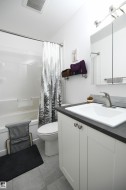 Like the kitchen, both bathrooms in the home have received a bright and contemporary renovation.  The white cabinetry, new fixtures, solid surface counters, and tile accents look great - 