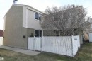 Located along an open green space and the Brander Gardens off leash walking trails, this spotless 3 bed townhome has a renovated, white kitchen with tile backsplash, updated bathrooms, a huge master bedroom, corner fireplace, & central AC - 5823 Riverbend Road, Edmonton, AB  - Outdoor 