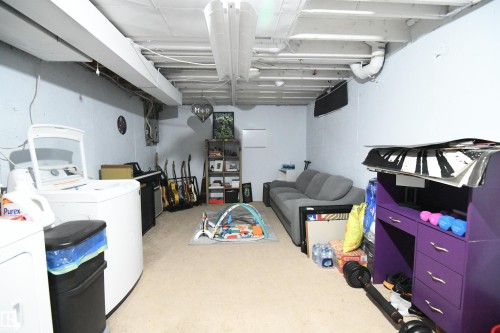 The basement is wide open and ready for your personal touches, if you want to finish out some additional space.  The laundry and utilities are conveniently set to the side of the unit, so as not to impede your development plans - 5823 Riverbend Road, Edmonton, AB - Indoor Photo Showing Laundry Room