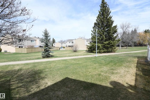 This unit is located immediately adjacent to this large, open, green space, and the paved trail allows you to explore Brander Gardens whenever you like.  The treed off leash area is also accessed from this paved pathway - 5823 Riverbend Road, Edmonton, AB - Outdoor