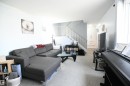 The open railings that lead upstairs to the bedroom level give an open feel to the large living room, with great furniture placement options.  The kitchen and large dining area are just around the corner to the right - 5823 Riverbend Road, Edmonton, AB  - Indoor 