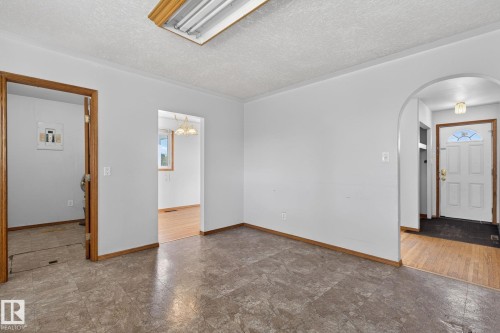 Neutral-toned flooring with light-colored walls and wood-finish trim throughout - 13412 108 Street, Edmonton, AB - Indoor Photo Showing Other Room
