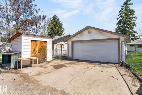 Detached single-car garage and separate storage shed with a wood-finish double door - 13412 108 Street, Edmonton, AB - Outdoor