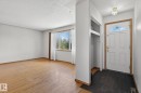 Bright entryway featuring a paneled door with an arched glass insert, recessed coat storage, and a flush-mount ceiling light - 13412 108 Street, Edmonton, AB  - Indoor Photo Showing Other Room 